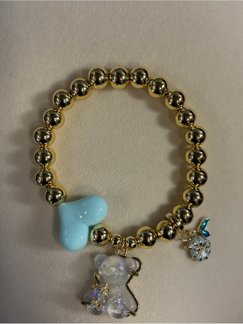 Gold Beaded Bracelet with Blue Heart & Iridescent Bear Charm